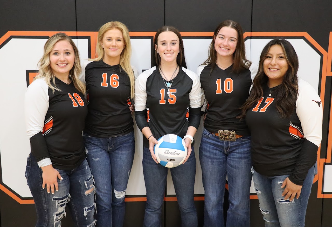 Five players in front of gym wall